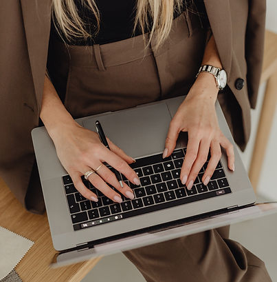 kaboompics_young-entrepreneur-dressed-in-brown-suit-holds-laptop-27938.jpg