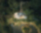 Aerial view of The Duck Pond Cabin at East Farm Glamping. Decking area with wood-fired hot tub and outdoor day bed.
