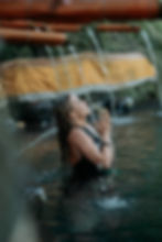 woman during purification ritual melukat in bali in hidden water temple