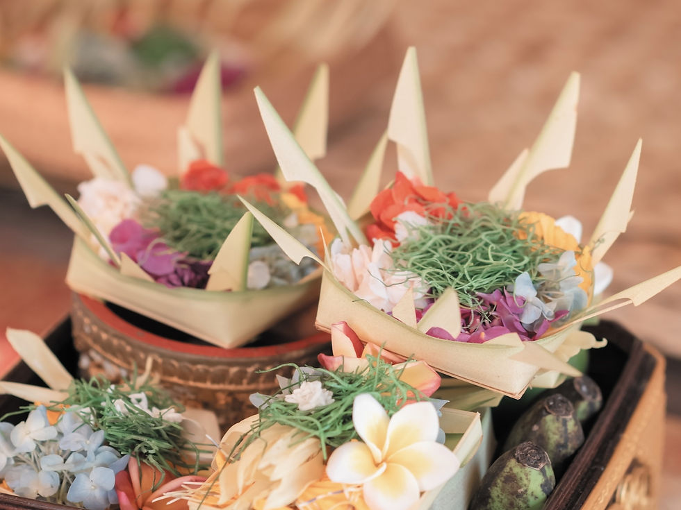Colorful Balinese flower offerings Canang Sari in woven baskets with banana leaves, placed on a wooden surface. Vibrant hues create a serene, festive mood.