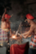 Balinese blacksmiths forging metal in a traditional workshop, creating sparks as part of the island’s artisan craftsmanship
