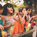 Kids Blowing Bubbles Outdoors