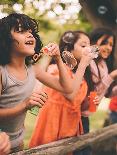 Bambini Blowing Bubbles
