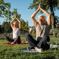 older-couple-practicing-yoga-outdoors