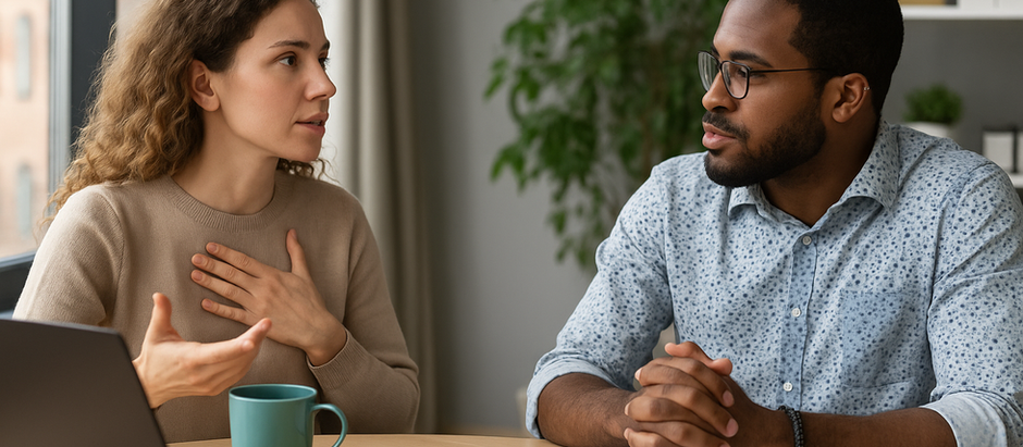 Two professional individuals sitting across from each other in a modern office, engaging in calm dialogue to navigate political differences with empathy and respect.