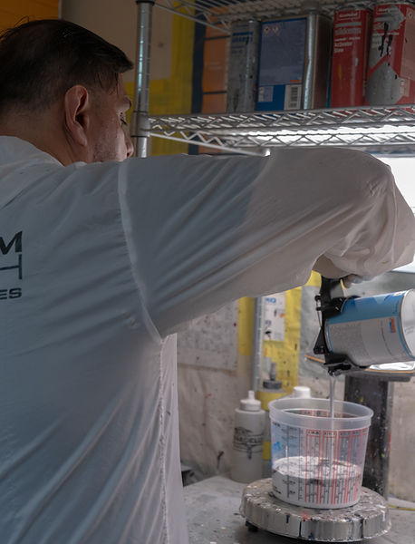 Certified painter mixing paint at Pabco Precision Auto Body in Modesto CA