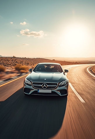 aerial view of mercedes e class cinematic look driving away.jpg