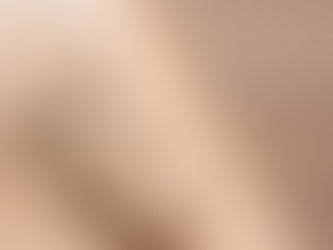 A close-up shows a leather bag strap with a metal buckle and stitching details resting diagonally on a wooden surface.