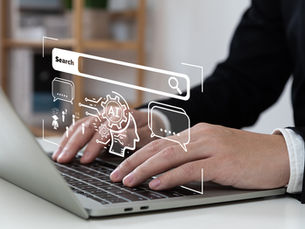 Hands typing on a laptop with digital AI graphics and speech bubbles overlay. The setting is a modern office with shelves in the background.