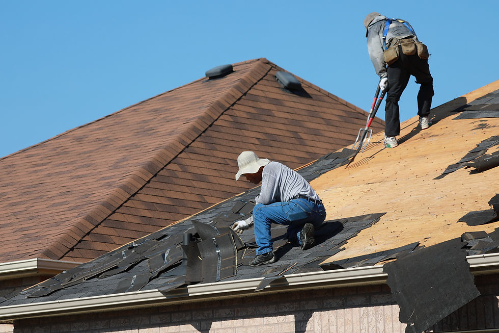 Old shingles being removed during roof replacement