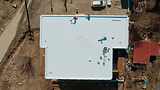 Calgary commercial roof maintenance technician inspecting membrane