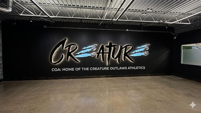 Creature Outlaws Athletics gym wall with COA logo