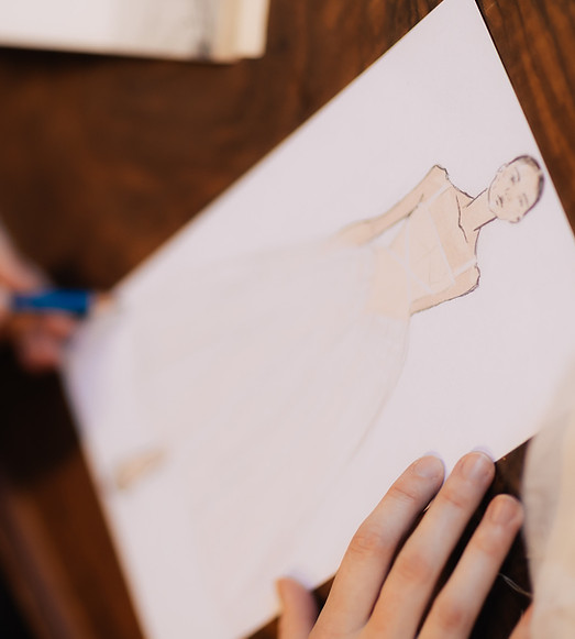 Bronwn Bridge designing a custom wedding dress. Close-up photograph of bespoke wedding dress sketches.