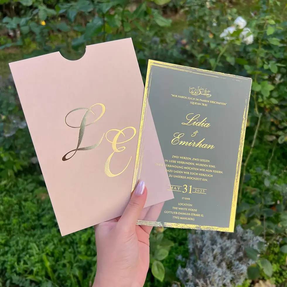 Hand holding wedding invitation with gold text and L E initials, Destiny Invitation.