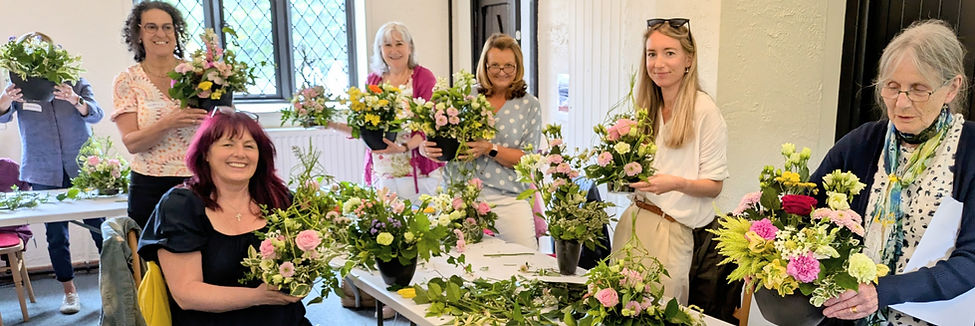a group of ladies arranging flowers