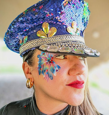 Lady with a face art glitter eye design wearing and colourful sequin cap