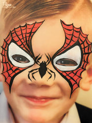 Boy with a spiderman face paint design on his face