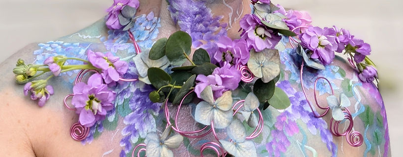 Lilac and turquoise flowers and painted flowers on a ladies neck and shoulders