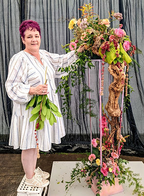 Lady creating a floral pedestal arrangement