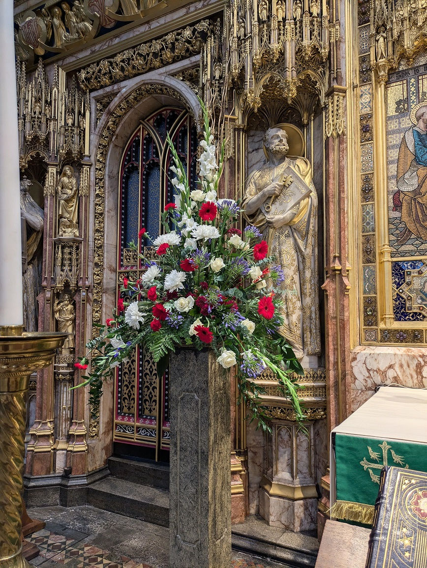 Red white and blue pedestal flower arrangement at Westminster Abbey