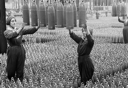 Two women in a munitions factory, surrounded by ammunition
