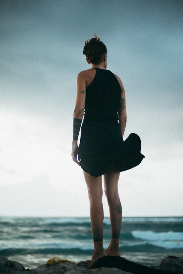 woman being still looking out into the ocean