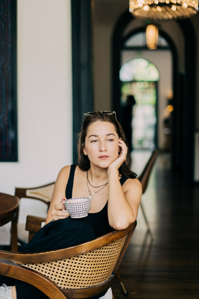businesswoman with coffee looking exhausted
