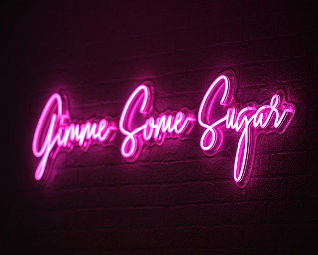 pink neon sign saying give me some sugar