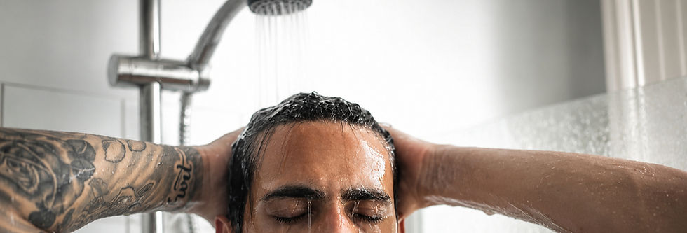man with fresh tattoo showering