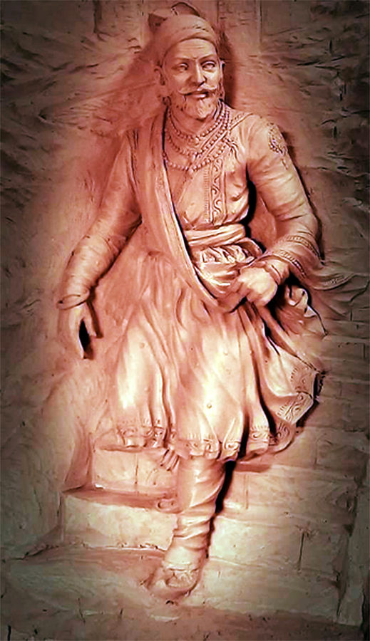 a statue of a woman in a dress with a scarf around her neck