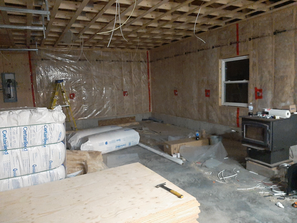 Insulated walls, non insulated ceiling, wires hanging down from the wooden roof truss.