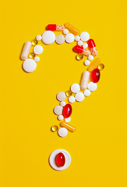 Medicines on a yellow background together forming a question mark