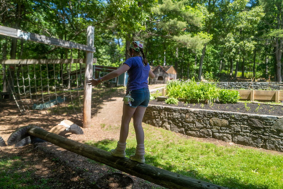 middle school student playing on balance beam