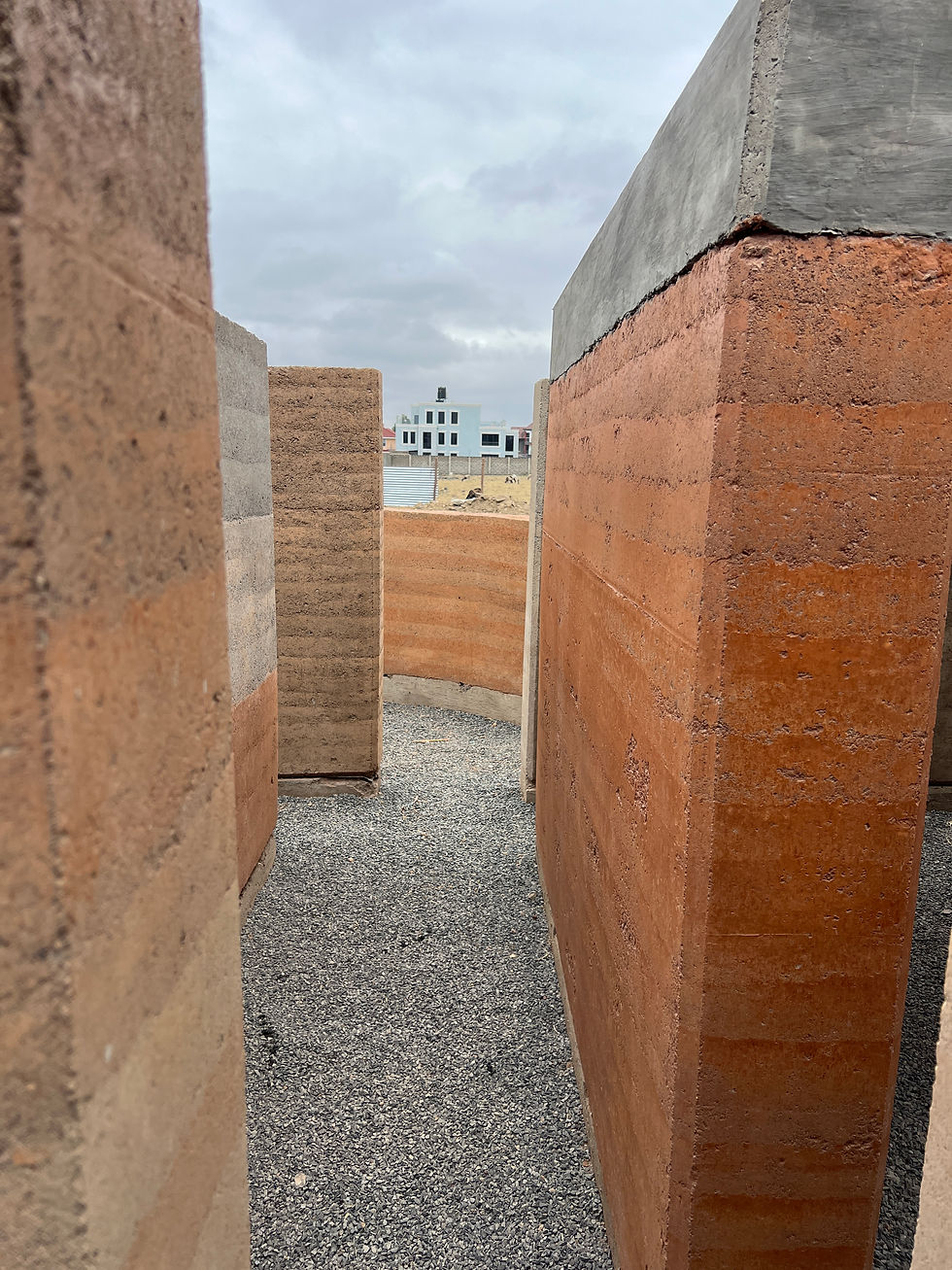 Contemporary rammed-earth architecture for Tanzania combining natural soil materials and modern sustainable building design.