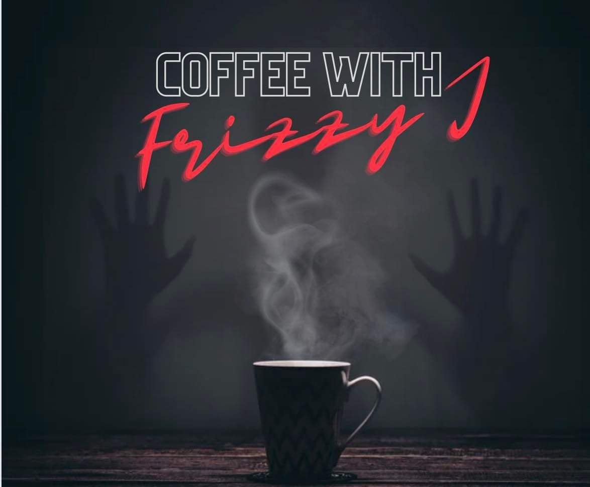 This image is of a steaming mug of coffee on a dark wood table with silhouette hands behind it as if pressed up against glass.  Centered in the middle it says: "FROM THE MIND OF Frizzy J"