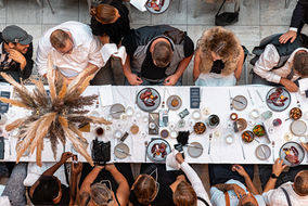 Hulstkamp Gebouw Rotterdam overhead view of guests dining at a long table with a dried-flower runner