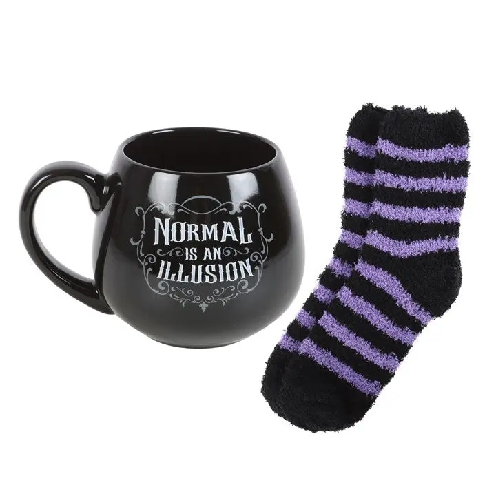 Black mug saying Normal is an Illusion with striped socks
