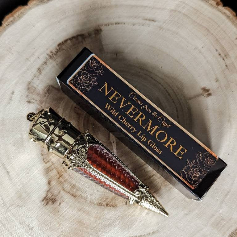 Thumbnail: Nevermore Wild Cherry Lip Gloss in ornate gold packaging