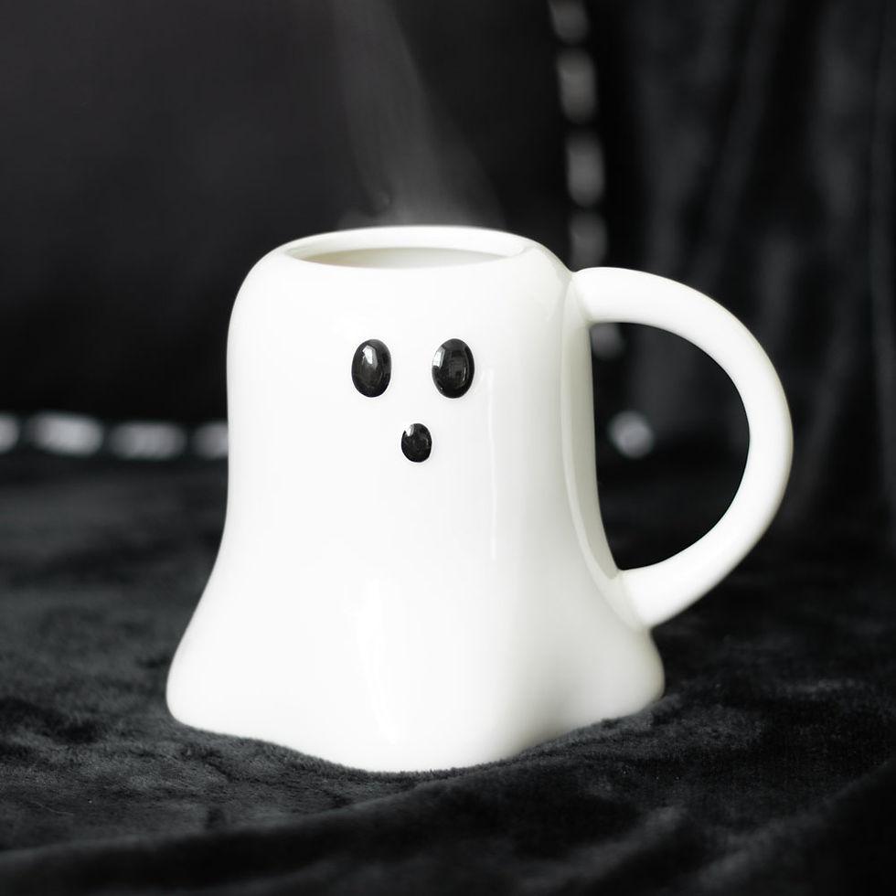 Steaming ghost-shaped white ceramic mug with a cute face.