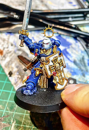 Holding Tiny Blue Guy w Sword.jpg