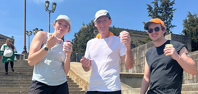 Group of people smiling and holding ice cream