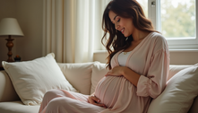 A pregnancy woman sitting on a couch