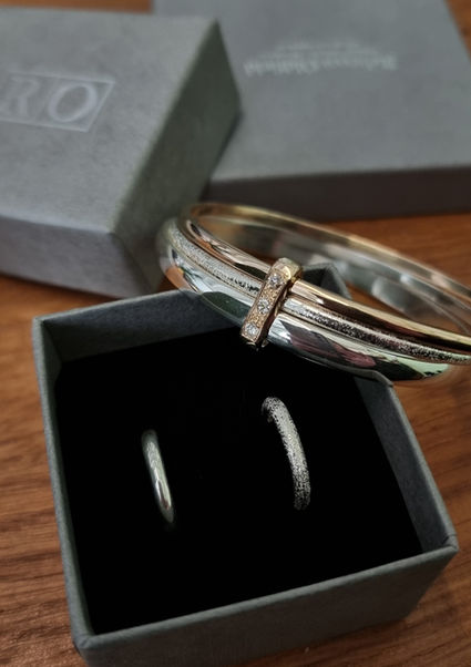 gold and silver bangles with diamonds and textured stacking rings