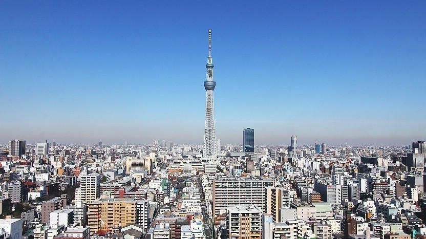 Tokyo Skytree towers above the bustling cityscape, offering a striking contrast between modern architecture and the sprawling urban environment.