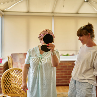 an actress checks her face after having hair and make-up done