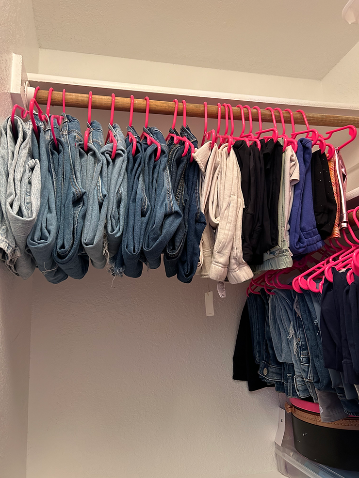 Jeans organized by Neat & Clean Services in a closet