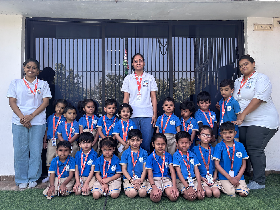 A group photo of preschool students in blue uniforms with their teachers and staff members at Trinity Pedagogy Daycare and Activity Center.