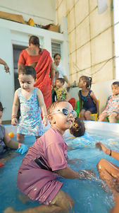 Students enjoying a supervised outdoor splash pool activity.