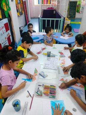 Children focused on a creative drawing and coloring project.