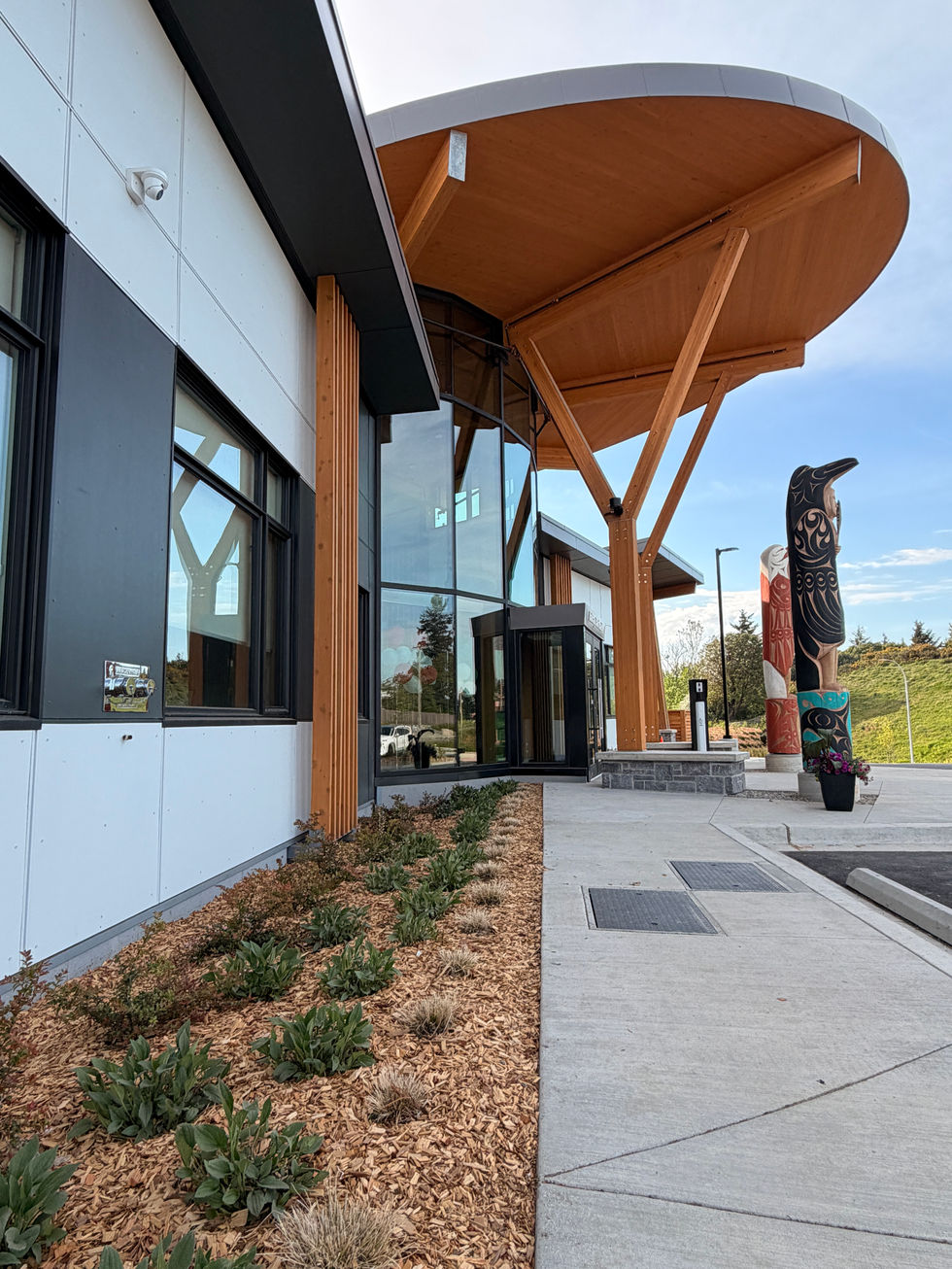 Modern building exterior with wooden accents and landscaping.